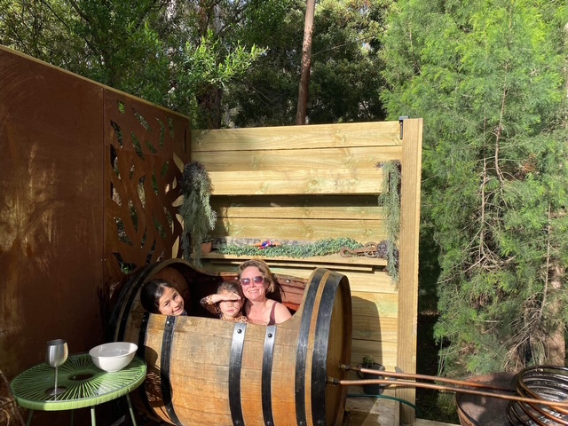 Mum and children enjoying a barrel bath